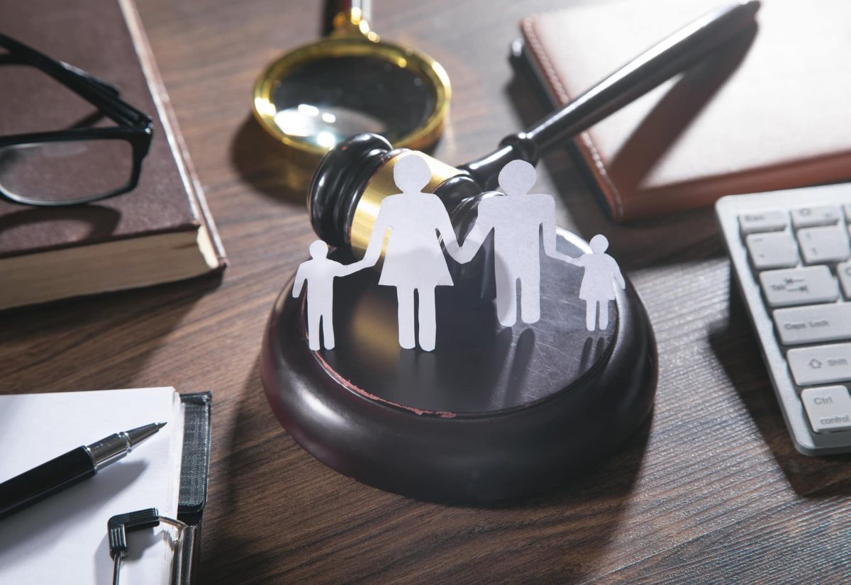 Paper cut family, judge gavel, book and other objects. Family Law